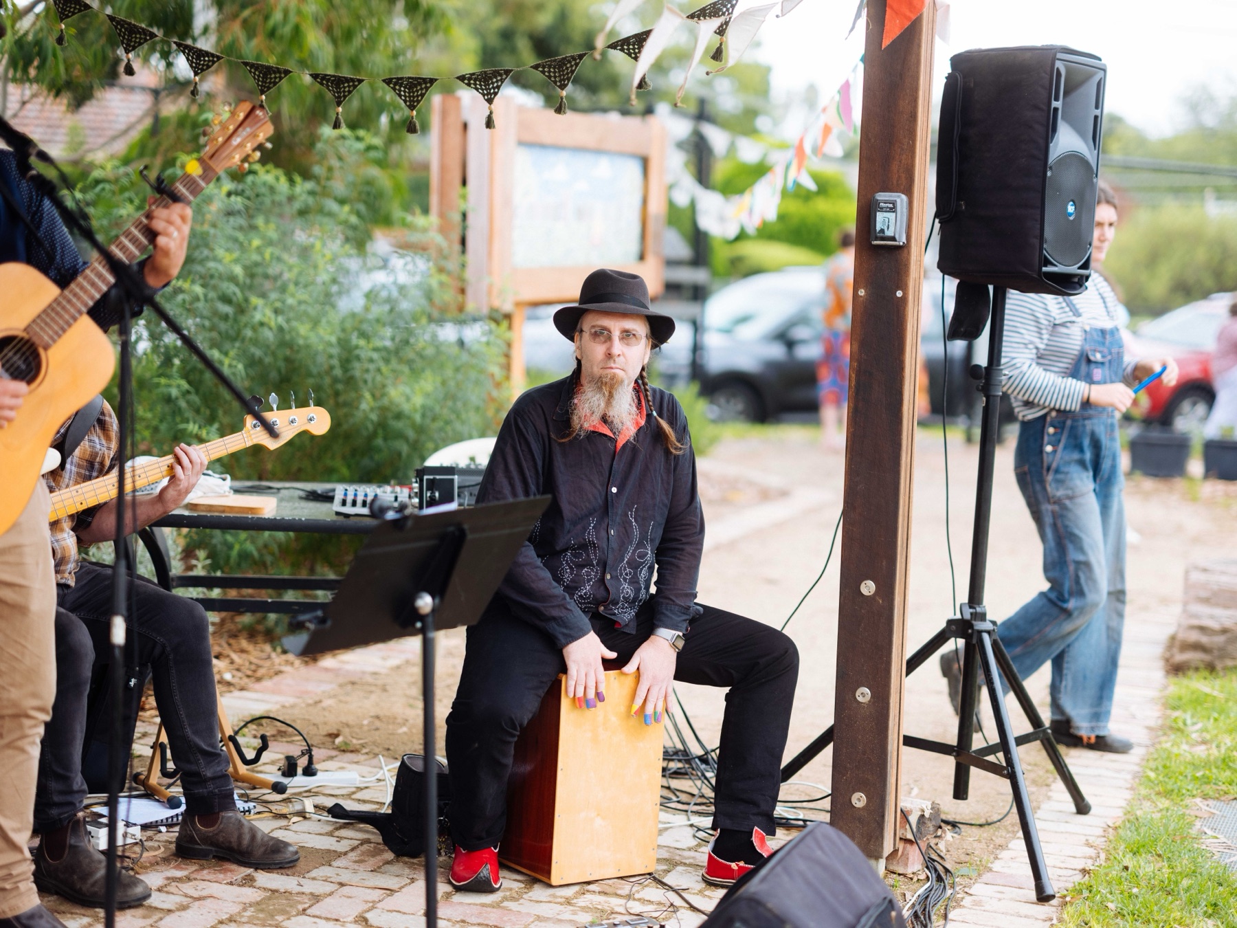 The cajon player keeping time during a song at the garden concert