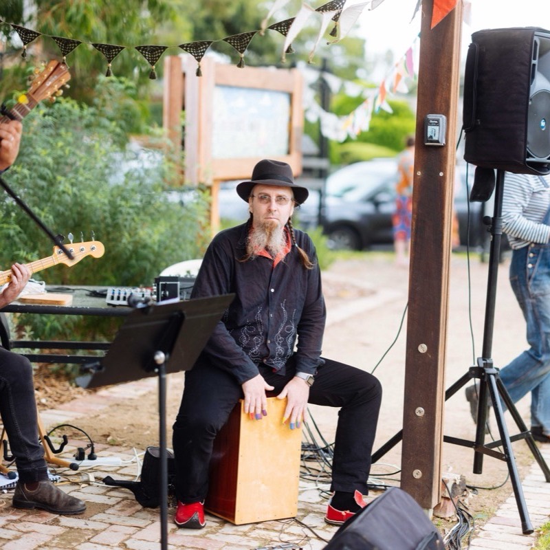 The cajon player keeping time during a song at the garden concert